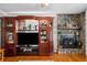 Living room boasts stone fireplace, hardwood flooring and an entertainment center, perfect for cozy nights at 1822 Morgan Rd, Canton, GA 30115