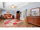 Bright primary bedroom with trey ceilings, hardwood floors and seating area featuring wooden furniture at 1822 Morgan Rd, Canton, GA 30115
