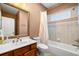 Cozy bathroom featuring tiled shower-tub combination and vanity with framed mirror at 5415 Old Haven Ct, Cumming, GA 30041
