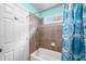Bathroom showcasing a tub and shower with neutral paint and colorful accents at 5415 Old Haven Ct, Cumming, GA 30041