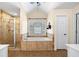 Bright bathroom showcasing a large soaking tub and separate glass enclosed shower at 5415 Old Haven Ct, Cumming, GA 30041