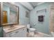 Bathroom with light blue walls, stone tile, and vanity at 5415 Old Haven Ct, Cumming, GA 30041