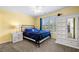 Bedroom with yellow walls, plantation shutters, and an armoire at 5415 Old Haven Ct, Cumming, GA 30041