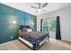 Comfortable bedroom with a decorative blue wall, ceiling fan, and bright window at 5415 Old Haven Ct, Cumming, GA 30041