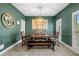 Elegant dining room with wood table set, green walls, chair rail, and large window at 5415 Old Haven Ct, Cumming, GA 30041