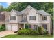 Charming two-story home featuring a brick-and-siding facade, manicured landscaping, and a welcoming two-car garage at 5415 Old Haven Ct, Cumming, GA 30041