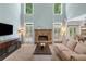 Bright living room with high ceilings, a stone fireplace, and ample natural light at 5415 Old Haven Ct, Cumming, GA 30041