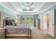 Relaxing main bedroom features a decorative tray ceiling with fan and connecting bathroom at 5415 Old Haven Ct, Cumming, GA 30041