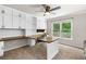 Home office with a custom-built desk, cabinets, and a window at 5415 Old Haven Ct, Cumming, GA 30041