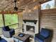 Cozy screened patio with a brick fireplace, comfortable seating, and charming string lights at 5415 Old Haven Ct, Cumming, GA 30041