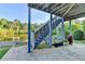 Basement patio under a deck with a water view and access to the backyard at 1943 Blue Heron Way, Lawrenceville, GA 30043