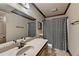 Bathroom featuring neutral vanity, patterned shower curtain and tile floors at 1943 Blue Heron Way, Lawrenceville, GA 30043