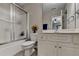 Well-lit bathroom with a frosted glass shower door, white cabinets, and a neutral color palette at 1943 Blue Heron Way, Lawrenceville, GA 30043