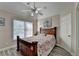 Comfortable bedroom features a ceiling fan, natural light, and stylish wood-look flooring at 1943 Blue Heron Way, Lawrenceville, GA 30043