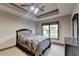 Bedroom featuring neutral carpet, tray ceiling and ample natural light at 1943 Blue Heron Way, Lawrenceville, GA 30043