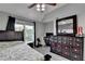Well-lit bedroom with ceiling fan, desk, vanity and hardwood flooring at 1943 Blue Heron Way, Lawrenceville, GA 30043