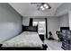 Light filled bedroom features a ceiling fan, large window, and hardwood flooring at 1943 Blue Heron Way, Lawrenceville, GA 30043