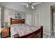 A cozy bedroom with a classic wood frame bed, soft lighting, and neutral wall colors at 1943 Blue Heron Way, Lawrenceville, GA 30043