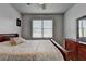 Comfortable bedroom featuring neutral tones, a bed with a decorative duvet, and a dark wooden dresser at 1943 Blue Heron Way, Lawrenceville, GA 30043
