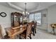 Formal dining room features a coffered ceiling, chandelier, and ample space for large gatherings at 1943 Blue Heron Way, Lawrenceville, GA 30043