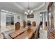 An elegant dining room featuring a beautiful chandelier and an extra long table at 1943 Blue Heron Way, Lawrenceville, GA 30043