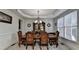 Formal dining room with a decorative chandelier, carpeted floors, and bright window at 1943 Blue Heron Way, Lawrenceville, GA 30043