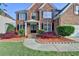 Charming two-story brick home with a manicured lawn and beautiful landscaping at 1943 Blue Heron Way, Lawrenceville, GA 30043