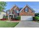 Beautiful two-story brick home with a two-car garage and well-maintained landscaping at 1943 Blue Heron Way, Lawrenceville, GA 30043