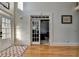 Spacious foyer with hardwood floors, interior and exterior doors with glass panes at 1943 Blue Heron Way, Lawrenceville, GA 30043