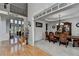 Inviting foyer with hardwood floors, staircase, and view into the formal dining room with elegant furniture at 1943 Blue Heron Way, Lawrenceville, GA 30043