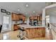 Kitchen with island and bar seating, stainless steel appliances, and wood cabinets at 1943 Blue Heron Way, Lawrenceville, GA 30043