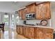 Stylish kitchen featuring wooden cabinets, stainless steel appliances, and access to the breakfast area at 1943 Blue Heron Way, Lawrenceville, GA 30043