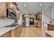 Modern kitchen with stainless steel appliances, cooktop, wood cabinets, and hardwood floors at 1943 Blue Heron Way, Lawrenceville, GA 30043