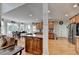 Open kitchen featuring wood cabinets, stainless steel appliances, and an island with bar seating at 1943 Blue Heron Way, Lawrenceville, GA 30043