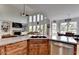 Kitchen area showcases wood cabinetry, stainless steel appliances, and a seamless transition to the living room at 1943 Blue Heron Way, Lawrenceville, GA 30043