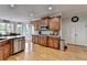 Bright kitchen with wood cabinets, stainless steel appliances, backsplash and hardwood floors at 1943 Blue Heron Way, Lawrenceville, GA 30043