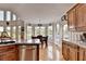 Kitchen with wood cabinets, stainless steel dishwasher, and a breakfast nook overlooking a backyard at 1943 Blue Heron Way, Lawrenceville, GA 30043