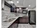 Kitchen with modern appliances, granite countertops, dark cabinets, and tiled backsplash at 1943 Blue Heron Way, Lawrenceville, GA 30043