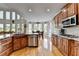 Modern kitchen with stainless steel appliances, granite countertops, wood cabinetry, and seamless flow to dining area at 1943 Blue Heron Way, Lawrenceville, GA 30043