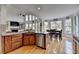 Well-designed kitchen featuring stainless steel appliances, wooden cabinets, and seamless flow to living and dining area at 1943 Blue Heron Way, Lawrenceville, GA 30043