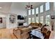 Spacious living room features soaring ceilings, stone fireplace, and large windows with lots of natural light at 1943 Blue Heron Way, Lawrenceville, GA 30043
