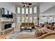 Bright living room with stone fireplace, large windows, hardwood floors, and open to the dining area at 1943 Blue Heron Way, Lawrenceville, GA 30043