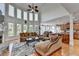 Open concept floorplan featuring a stone fireplace, large windows, and a seamless transition to the kitchen at 1943 Blue Heron Way, Lawrenceville, GA 30043