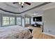 Spacious main bedroom boasts tray ceiling, wood floors, a large bay window, and a wall-mounted television at 1943 Blue Heron Way, Lawrenceville, GA 30043