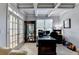 Well-lit office space with coffered ceilings, large desk and ample storage and exterior view at 1943 Blue Heron Way, Lawrenceville, GA 30043