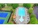 An aerial view of the community pool, featuring a sundeck, lounge chairs, and well-maintained landscaping at 1943 Blue Heron Way, Lawrenceville, GA 30043