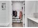 Bathroom with walk-in closet including clothes and a bench with storage boxes at 230 New St # 1303, Decatur, GA 30030