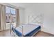 Bedroom with natural light from window with metal bed frame and wood floors at 230 New St # 1303, Decatur, GA 30030
