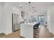 Bright, open kitchen with stainless steel appliances, white cabinets, and a large center island with seating at 230 New St # 1303, Decatur, GA 30030