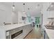 Spacious kitchen with stainless appliances, large island, and view to a living area and outdoor patio at 230 New St # 1303, Decatur, GA 30030